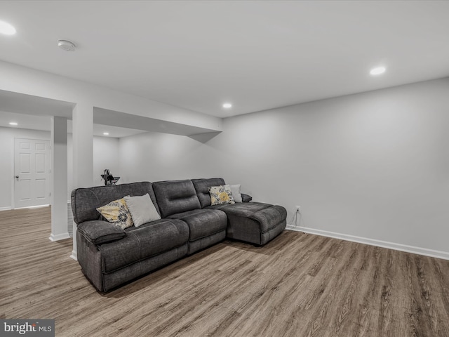 living area with light wood-type flooring, baseboards, and recessed lighting