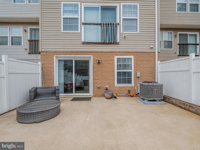 back of house with a patio, fence, central AC, and brick siding