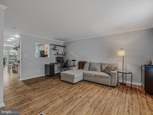 living area featuring ornamental molding, light wood-style flooring, and baseboards