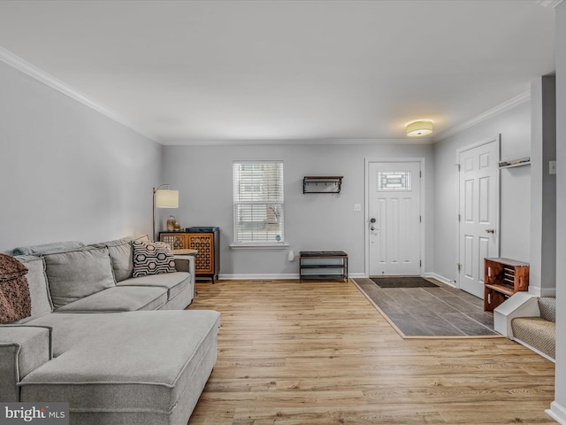 living area featuring light wood-style flooring, ornamental molding, and baseboards