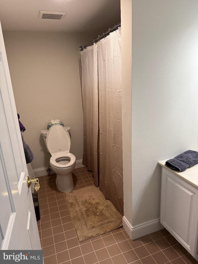 bathroom featuring tile patterned flooring, vanity, toilet, and a shower with shower curtain