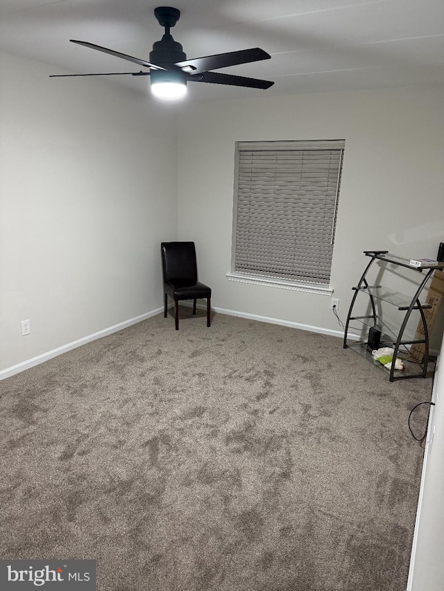 unfurnished room with ceiling fan and carpet