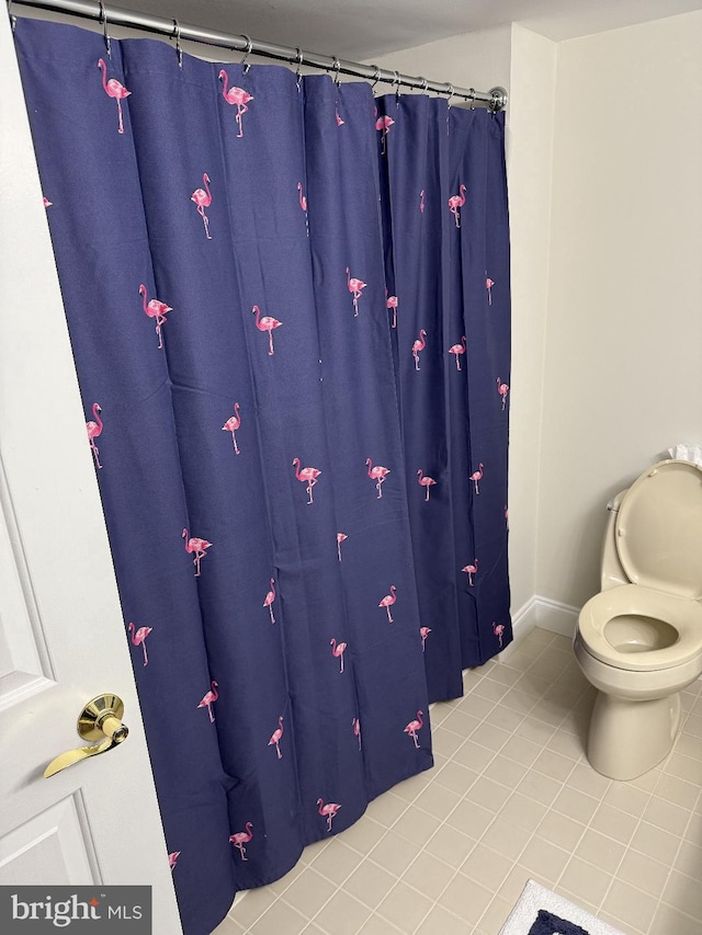 bathroom featuring tile patterned flooring and toilet