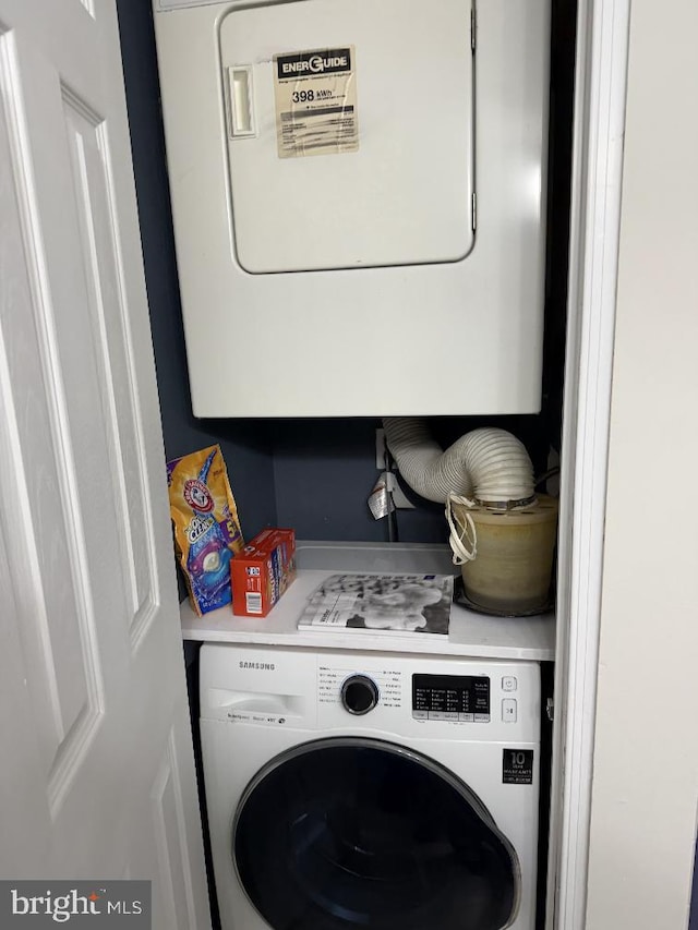 clothes washing area with stacked washer and dryer