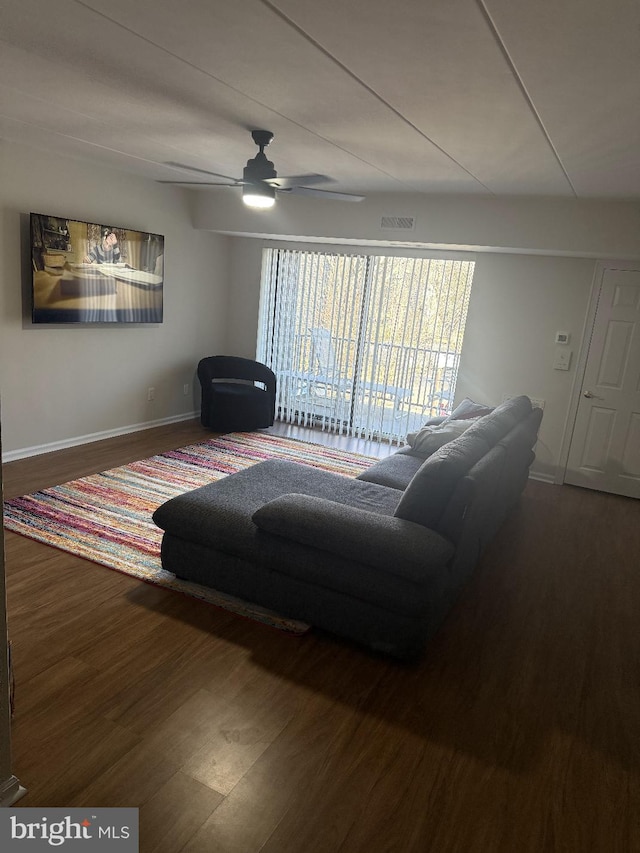 living room with wood-type flooring and ceiling fan