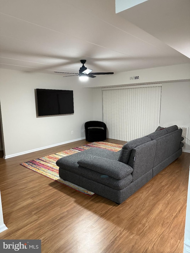 living room with hardwood / wood-style flooring and ceiling fan