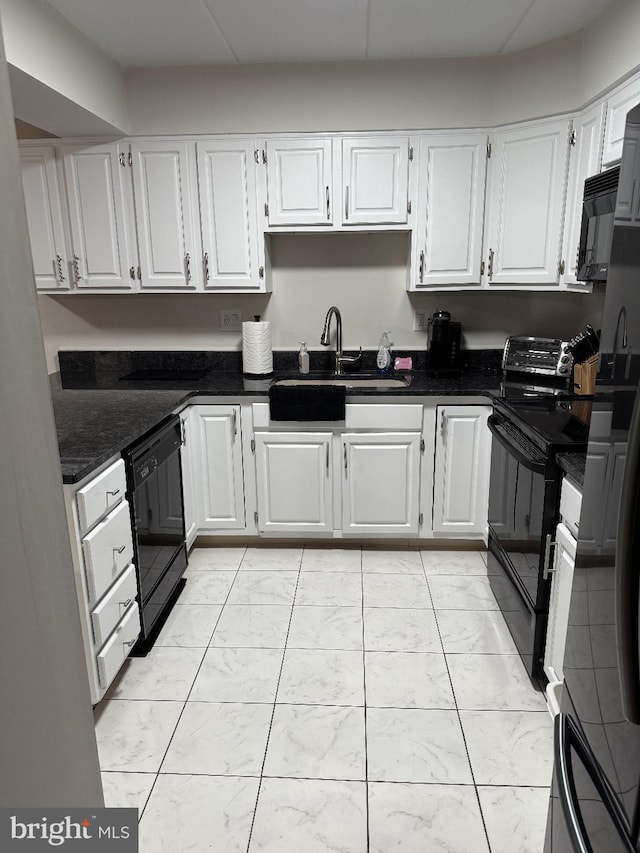 kitchen featuring dark stone countertops, black appliances, sink, and white cabinets