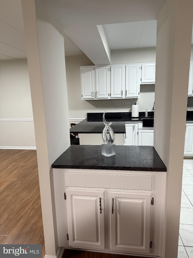 kitchen featuring light hardwood / wood-style floors and white cabinets