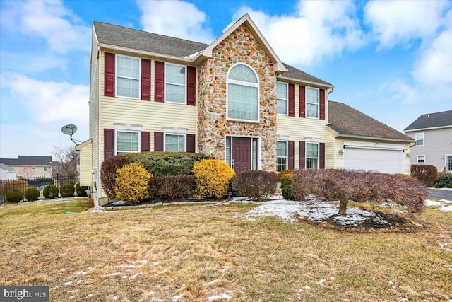 view of front facade featuring a garage and a front lawn