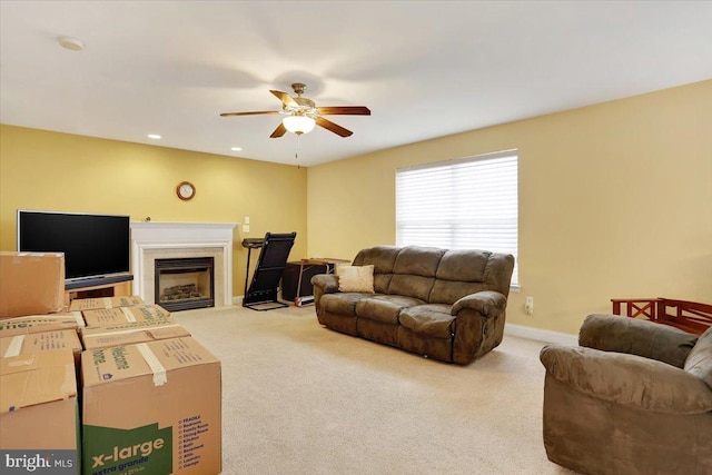 carpeted living room featuring ceiling fan