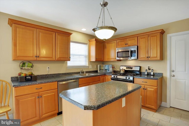 kitchen with pendant lighting, sink, appliances with stainless steel finishes, a kitchen island, and light tile patterned flooring