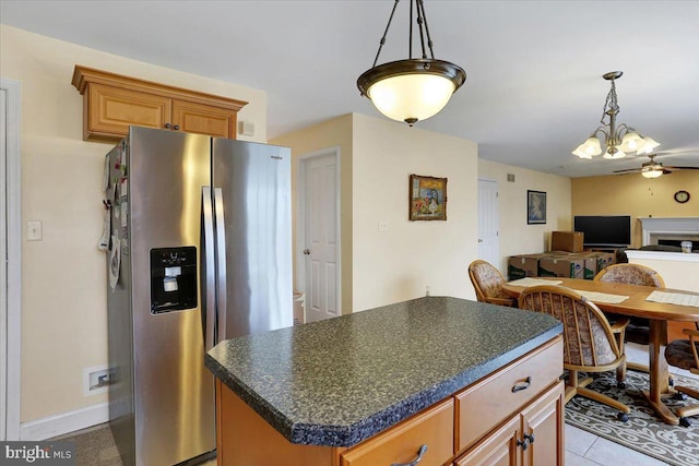 kitchen featuring stainless steel refrigerator with ice dispenser and a center island