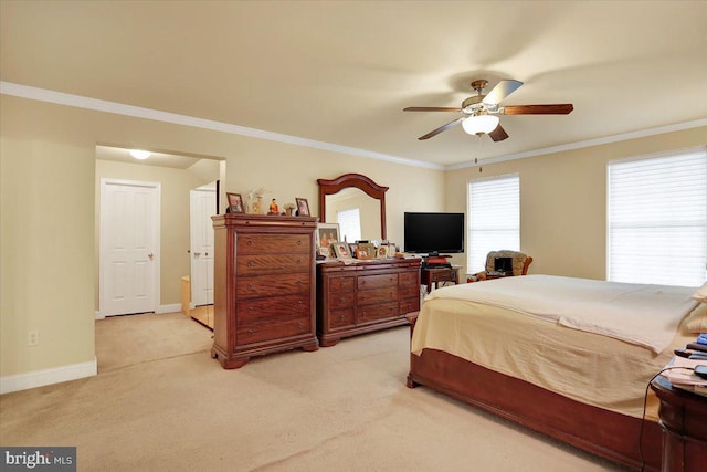 carpeted bedroom featuring ceiling fan and ornamental molding