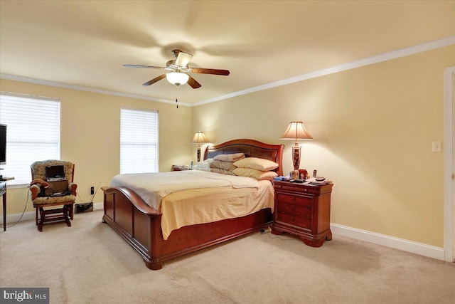 carpeted bedroom with ornamental molding and ceiling fan