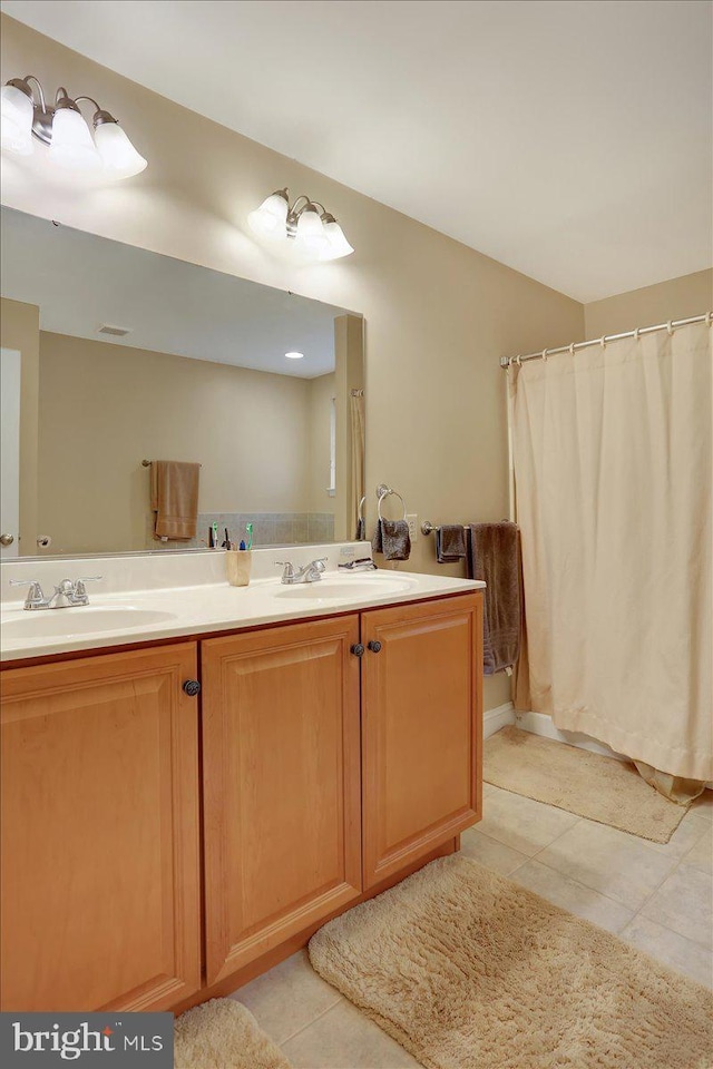 bathroom with tile patterned flooring and vanity