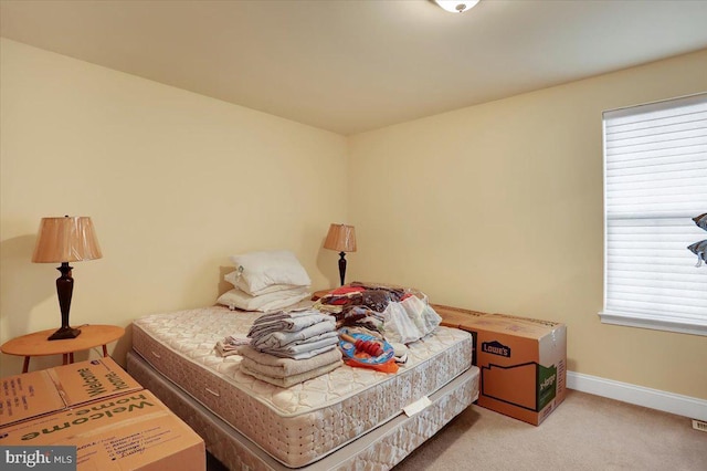 bedroom featuring light carpet