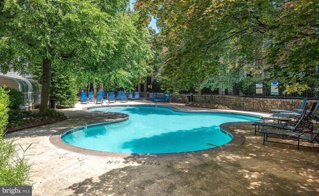 view of swimming pool with a patio area