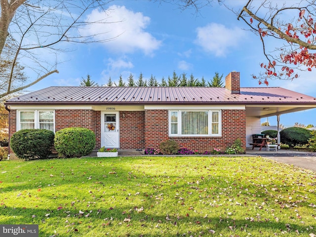 view of front of house with a patio area and a front yard