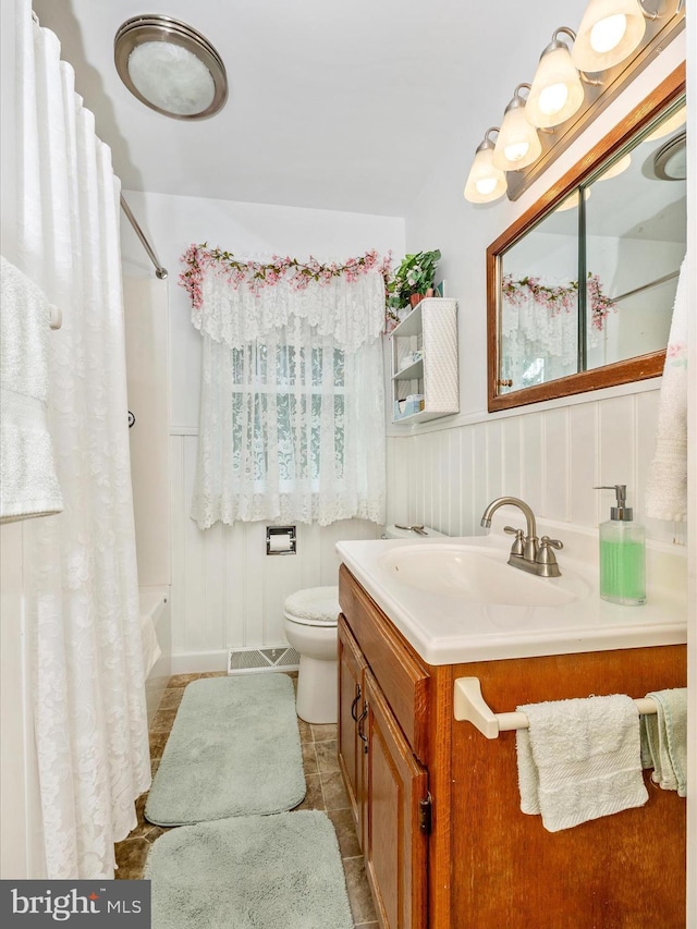 full bathroom with vanity, toilet, tile patterned flooring, and shower / bath combo with shower curtain