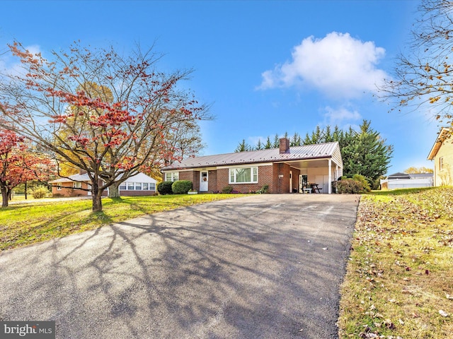 single story home with a front yard and a carport