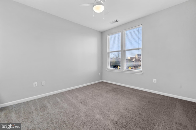 carpeted empty room featuring ceiling fan