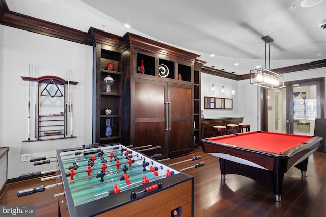 recreation room featuring pool table, dark wood-type flooring, ornamental molding, and indoor bar