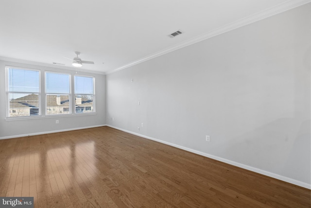 spare room with hardwood / wood-style flooring, ceiling fan, and ornamental molding