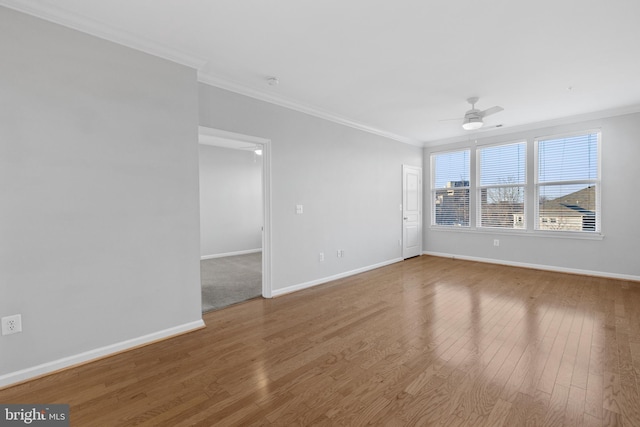 spare room featuring crown molding, wood-type flooring, and ceiling fan