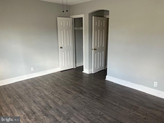 empty room with dark hardwood / wood-style floors