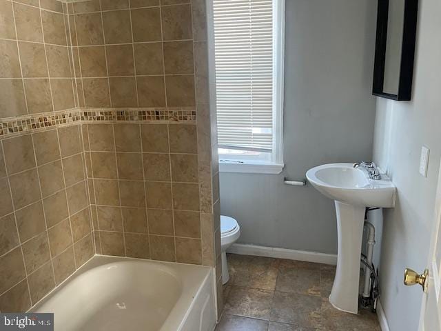 full bathroom with shower / washtub combination, sink, and toilet