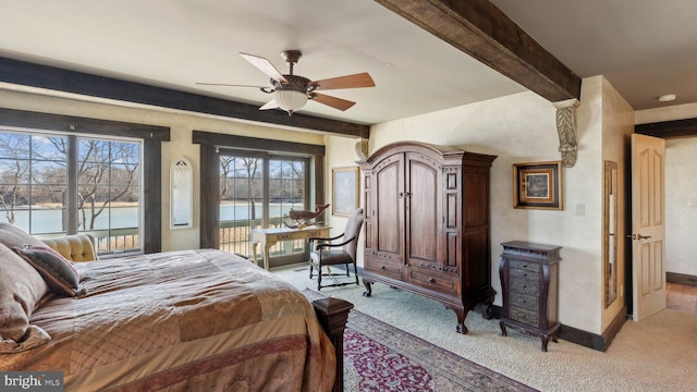 bedroom with a water view, light carpet, access to outside, beamed ceiling, and baseboards