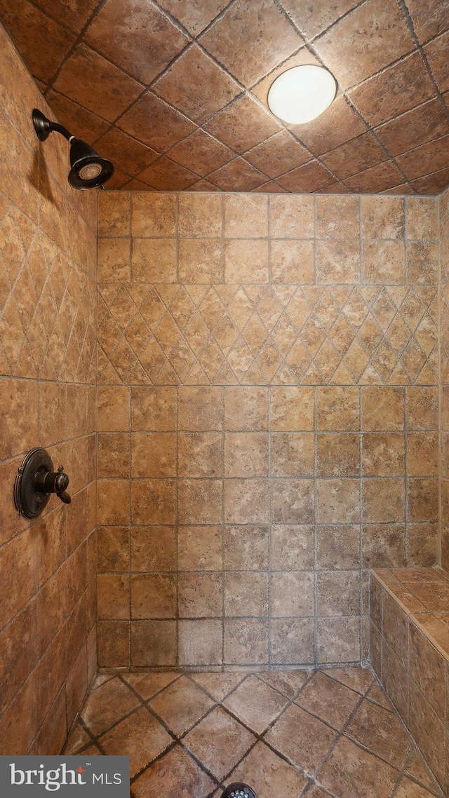 full bath with a tile shower