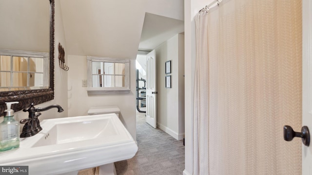 full bath with a sink and baseboards