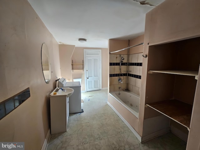 bathroom featuring tiled shower / bath and washer / clothes dryer