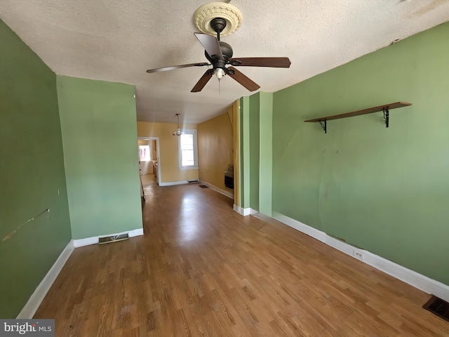 spare room featuring hardwood / wood-style floors, a textured ceiling, and ceiling fan