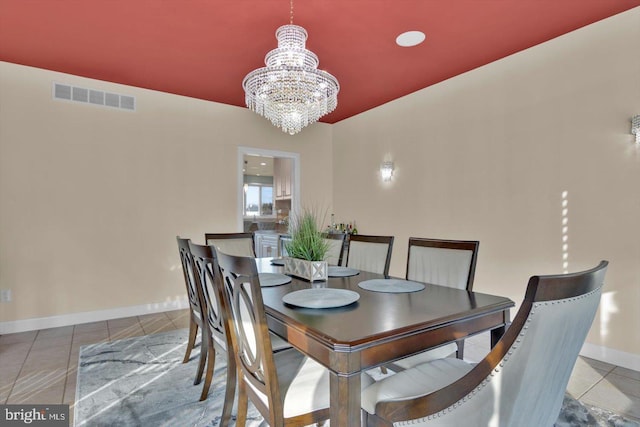 tiled dining area featuring an inviting chandelier