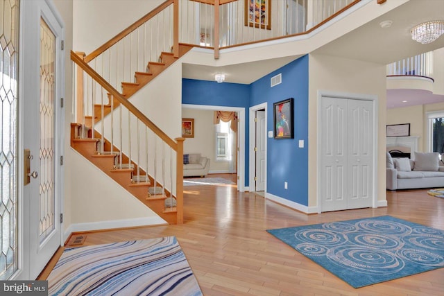 entrance foyer featuring hardwood / wood-style flooring and a high ceiling