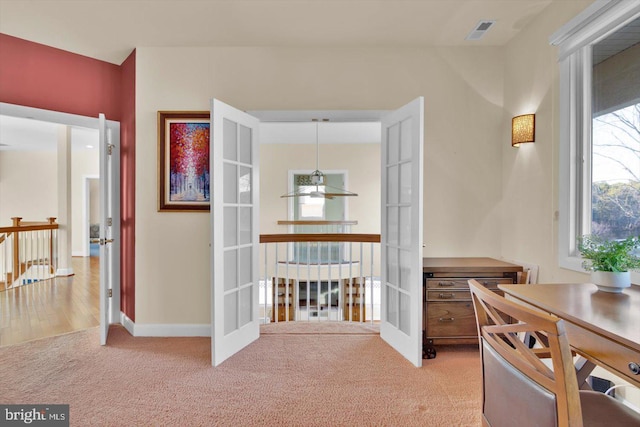 interior space featuring french doors and carpet flooring