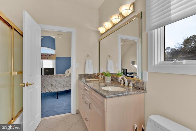 full bathroom featuring vanity, toilet, tile patterned flooring, and combined bath / shower with glass door