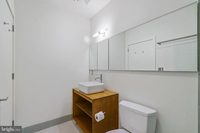 bathroom with vanity, tile patterned floors, and toilet