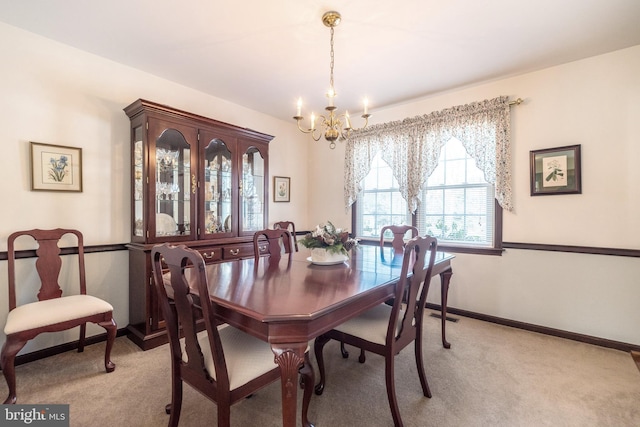 carpeted dining space featuring a notable chandelier