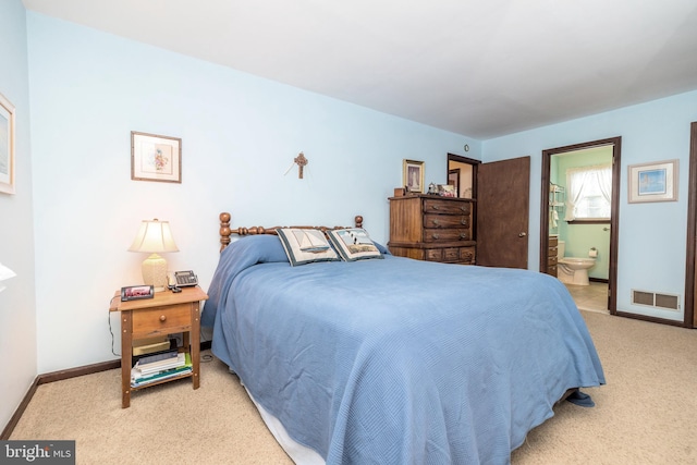 carpeted bedroom with connected bathroom