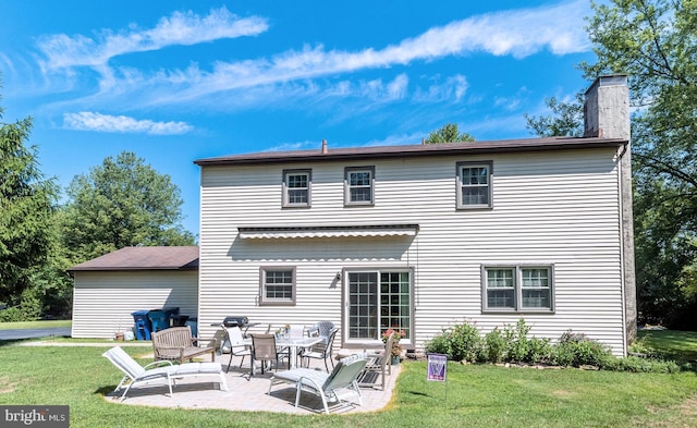 back of house with a yard and a patio area