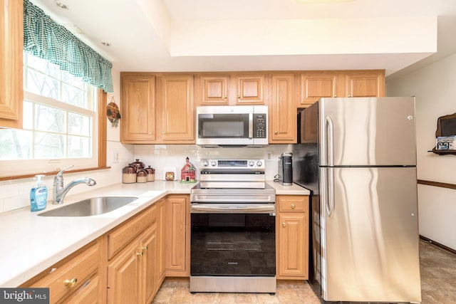 kitchen featuring tasteful backsplash, appliances with stainless steel finishes, and sink