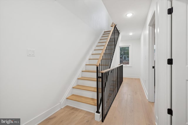 stairway featuring wood-type flooring