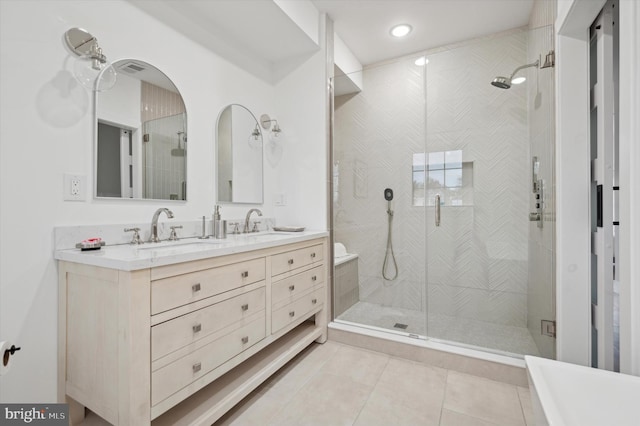 bathroom featuring vanity, tile patterned flooring, and a shower with door