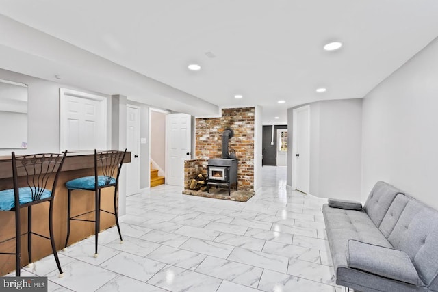 living room featuring bar and a wood stove