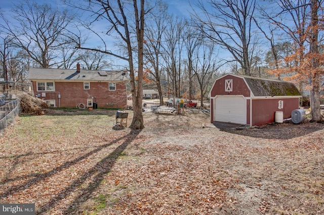 view of yard featuring a garage and an outdoor structure