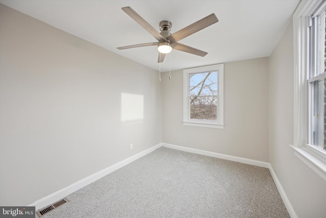 carpeted spare room with ceiling fan