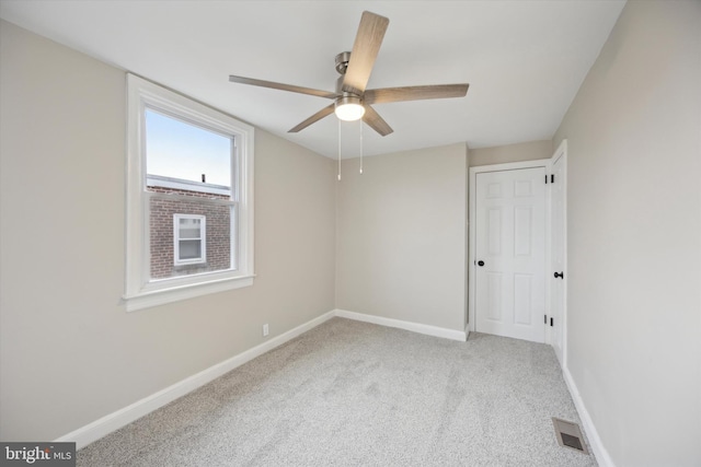 spare room featuring ceiling fan and carpet flooring